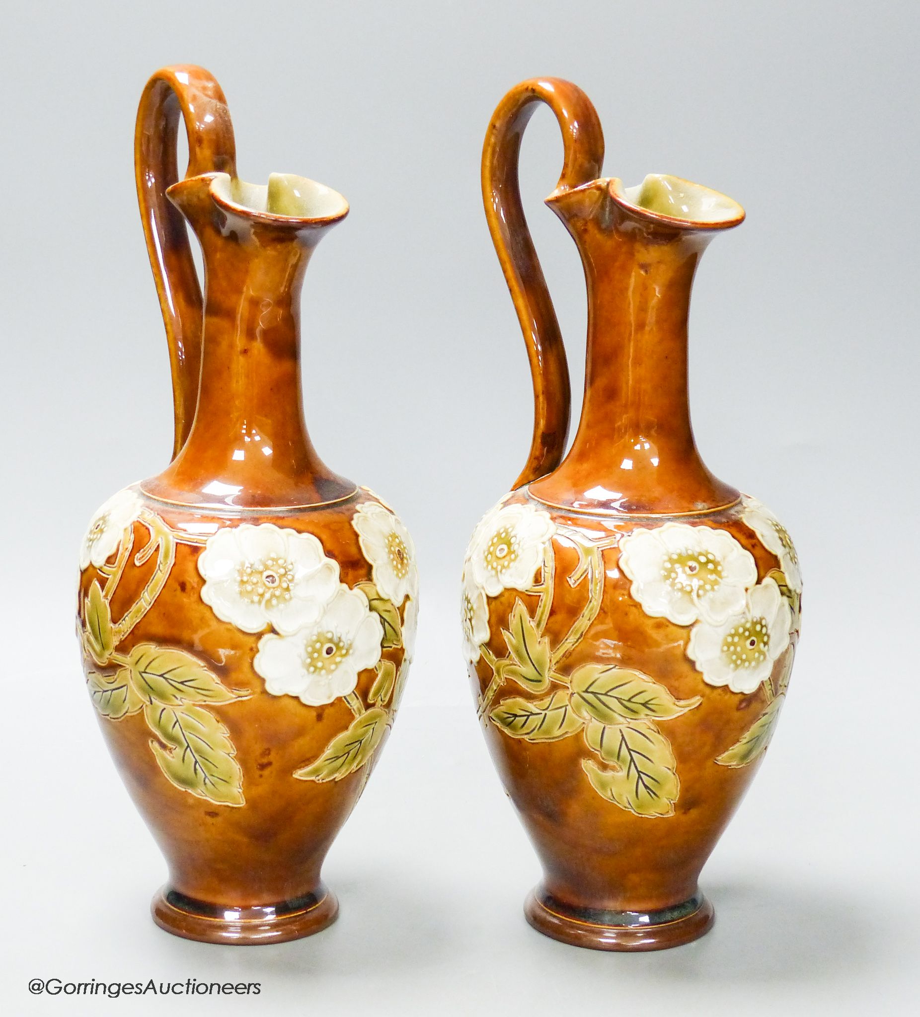 A pair of Royal Doulton stoneware ewers, height 30cm